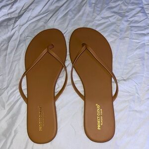 Never worn tan flip flops